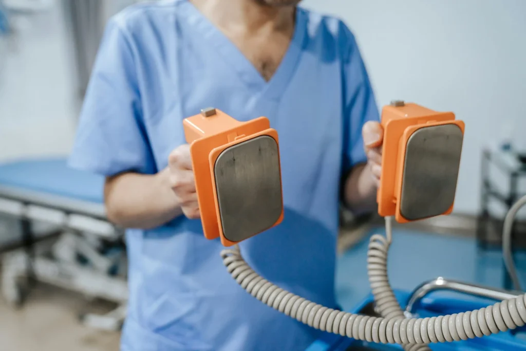 Person holding defibrillator equipment